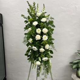 Tall white floral standing spray with roses and mums on a tripod easel