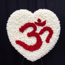 Heart-shaped floral tribute of white and red flowers on a stand