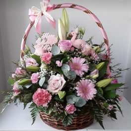 Pink floral basket with roses, lilies, and daisies