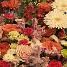 Mixed bouquet with roses, carnations, daisies, and alstroemeria in pink, orange, and white