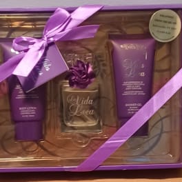 Purple gift set with lotion, perfume, and shower gel in a ribbon-tied box