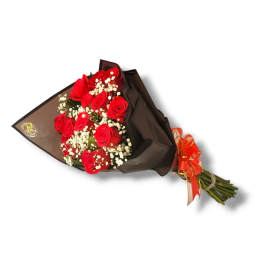 Bouquet of red roses wrapped in dark paper with a ribbon
