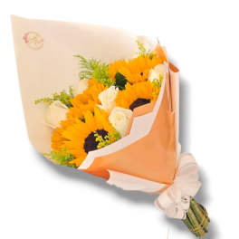 Bouquet of sunflowers and white roses wrapped in peach paper