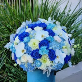 Blue and white floral arrangement in a blue vase