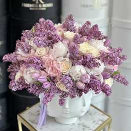 Pink and white bouquet in a white face vase