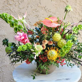 Colorful mixed floral arrangement in a round vase