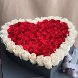 Heart-shaped box filled with red and white roses
