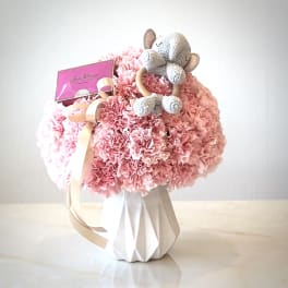 Pink carnation bouquet with a crocheted teddy bear and gift card
