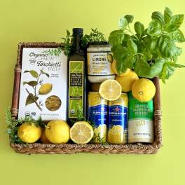 Gift basket with lemons, basil, pasta, sauce, olive oil, and sparkling drinks