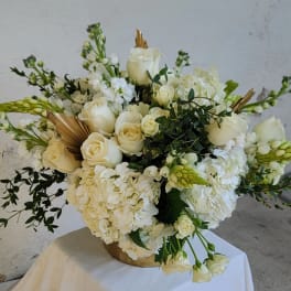 White rose and hydrangea arrangement in a gold vase