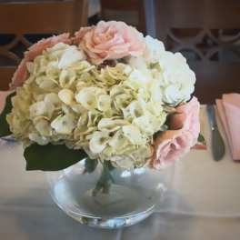 Pink and white hydrangea bouquet in a clear glass vase