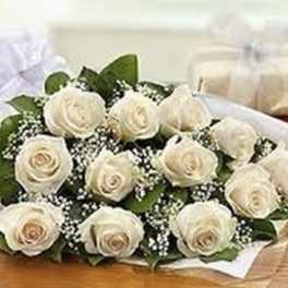 Bouquet of white roses with baby's breath wrapped in white paper