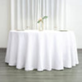 White-draped round table with a small floral centerpiece