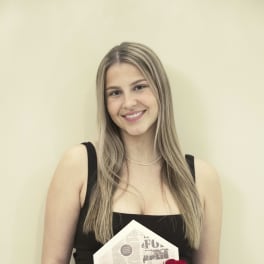 Woman holding a box of red roses wrapped in paper