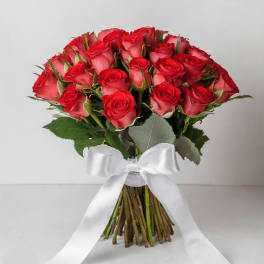 Bouquet of red roses tied with a white ribbon