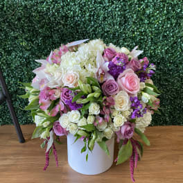 Large pastel flower arrangement in a white vase
