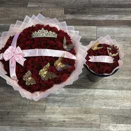 Two red rose bouquets with pink ribbon, tiaras, and butterfly decorations