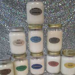 Stacked jar candles with labeled lids against a sequined backdrop
