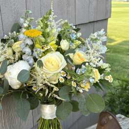 Bouquet of white and pale yellow flowers with eucalyptus