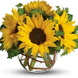 Bouquet of yellow sunflowers in a clear glass vase