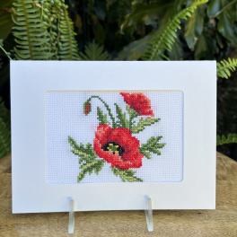 Card with a red poppy cross-stitch design
