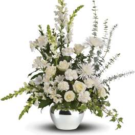 White floral arrangement in a silver vase with tall stems