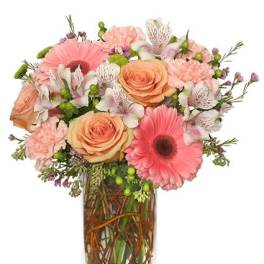 Pink and peach mixed bouquet in a clear rectangular vase