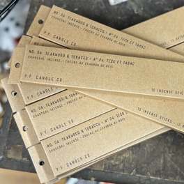 Stack of P.F. Candle Co. incense boxes labeled Teakwood & Tobacco