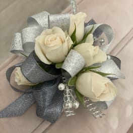 Cream rose corsage with silver ribbon and pearl accents