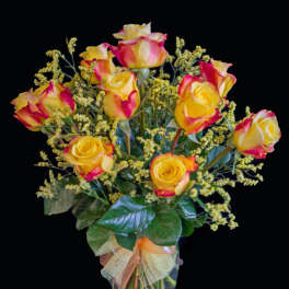 Bouquet of yellow and pink roses in a clear glass vase