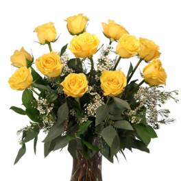 Yellow roses arranged in a clear glass vase