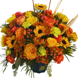 Orange and yellow mixed bouquet in a dark vase