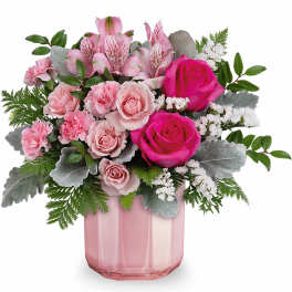 Pink roses and carnations in a pink glass vase