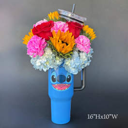 Colorful flower arrangement in a blue character tumbler with a lid