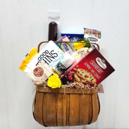 Gift basket with assorted snacks and two yellow flowers