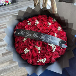 Bouquet of red roses with a black ribbon banner