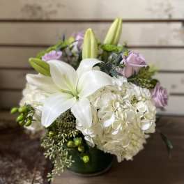 White lilies and hydrangeas with pale pink roses in a vase