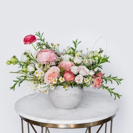 Pink and white mixed flower arrangement in a white vase