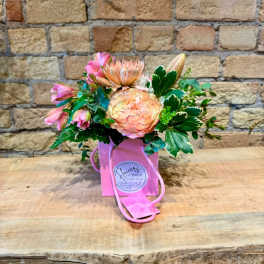 Pink and peach bouquet in a pink gift bag with rope handles