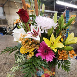 Mixed bouquet with lilies, roses, gerbera daisies, and chrysanthemums in a decorative box
