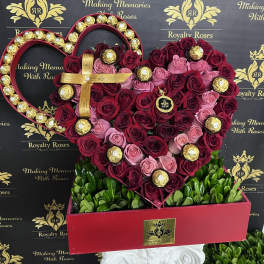 Heart-shaped rose arrangement with gold-wrapped chocolates in a red box