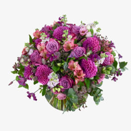 Bouquet of purple and pink flowers in a glass vase
