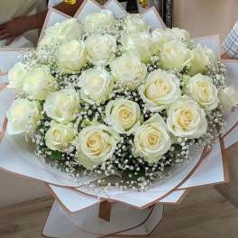Bouquet of white roses with baby's breath in white and blush wrap