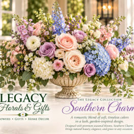 Pastel floral arrangement in a decorative urn vase