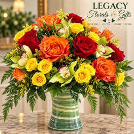 Bright mixed rose bouquet in a striped glass vase