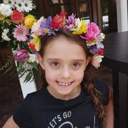 Girl wearing a colorful flower crown with mixed blooms