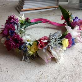 Floral crown with multicolored flowers and a pink ribbon tie