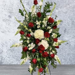 Tall standing floral spray with red roses and white flowers