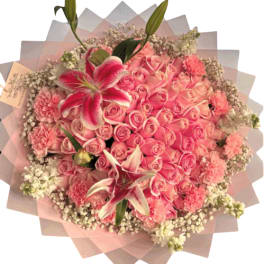 Pink rose bouquet with lilies and carnations wrapped in pastel paper