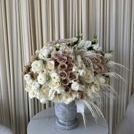 Large cream and blush rose arrangement in a gray urn vase